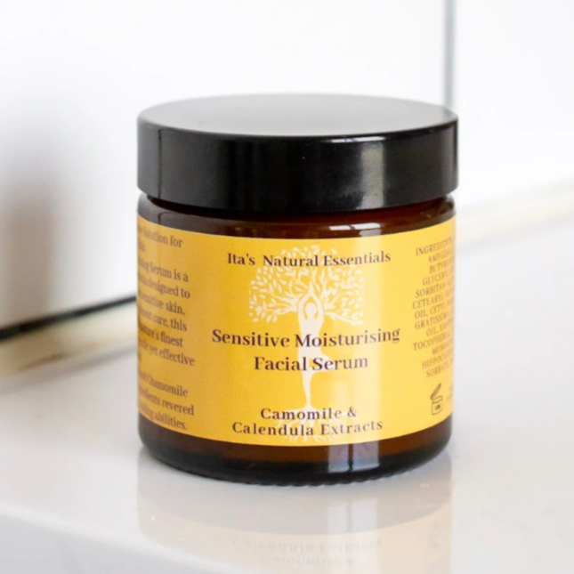 Jar of sensitive moisturizing facial serum on a bathroom counter with tiled wall background