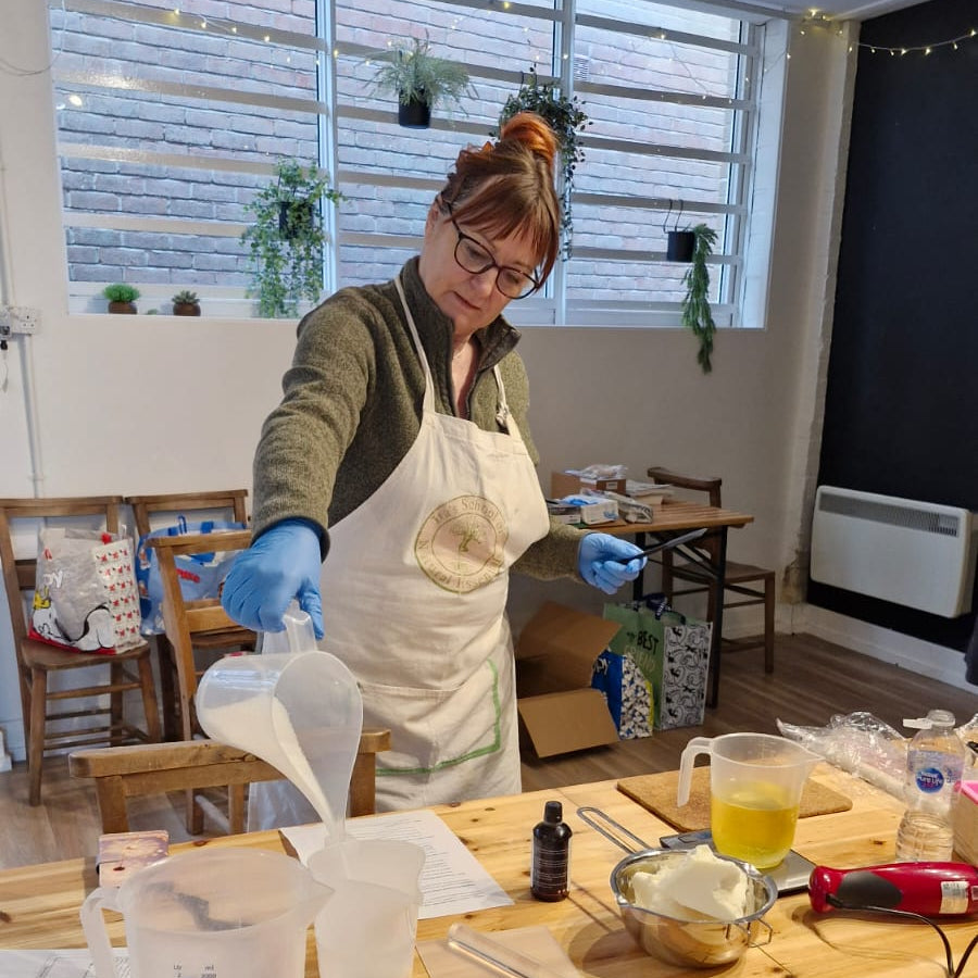 A student creating hand made soap in a beautiful light filled workshop