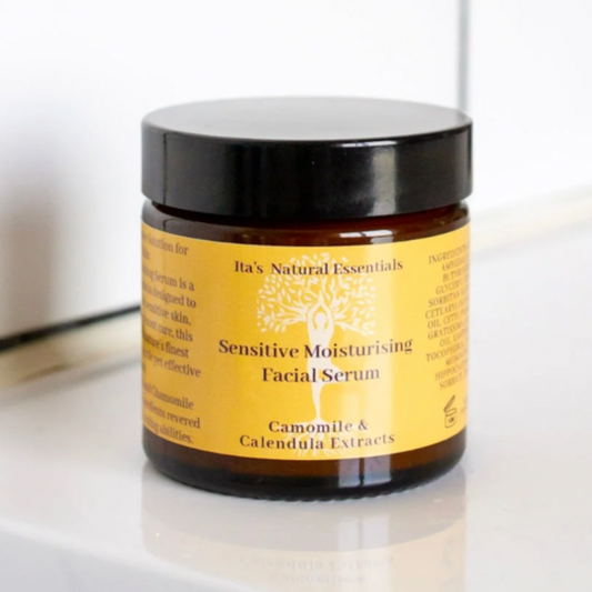 Jar of sensitive moisturizing facial serum on a bathroom counter with tiled wall background