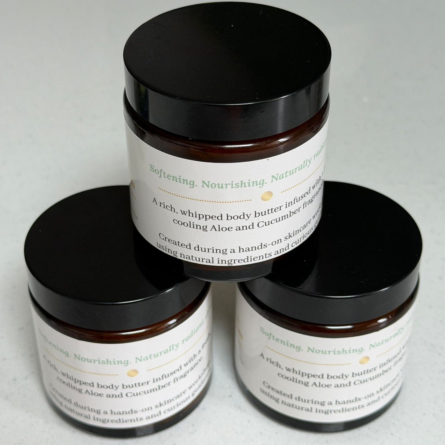 Three jars of Aloe & Cucumber Whipped Body Butter handmade by Ita's Natural Essentials, displayed in a pyramid arrangement on a white background.